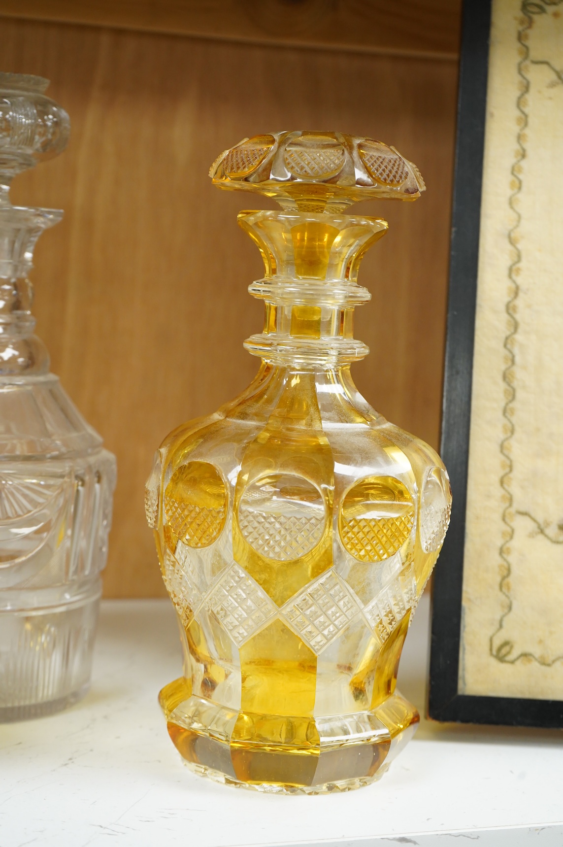 Two late 19th century Bohemian amber flashed decanters and another decanter, tallest 26cm